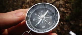 A traveler holds a compass in his hand to determine the direction of his movement